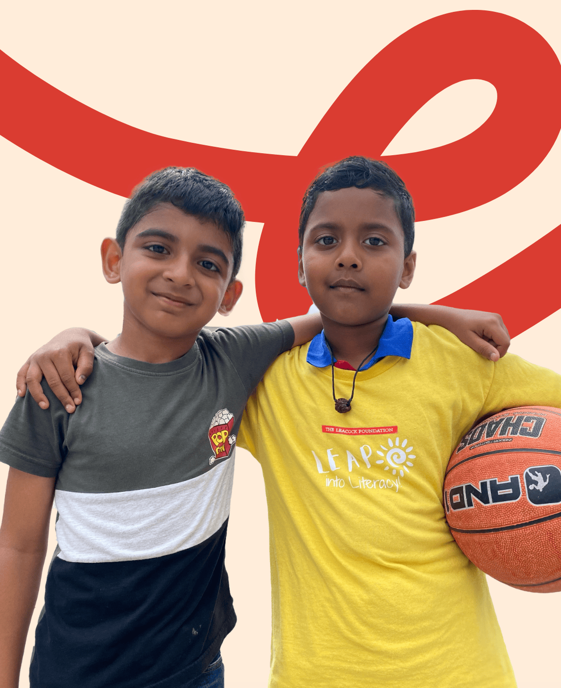 Photo of two LiftED program participants looking at the camera, with one of the participants holding a basketball