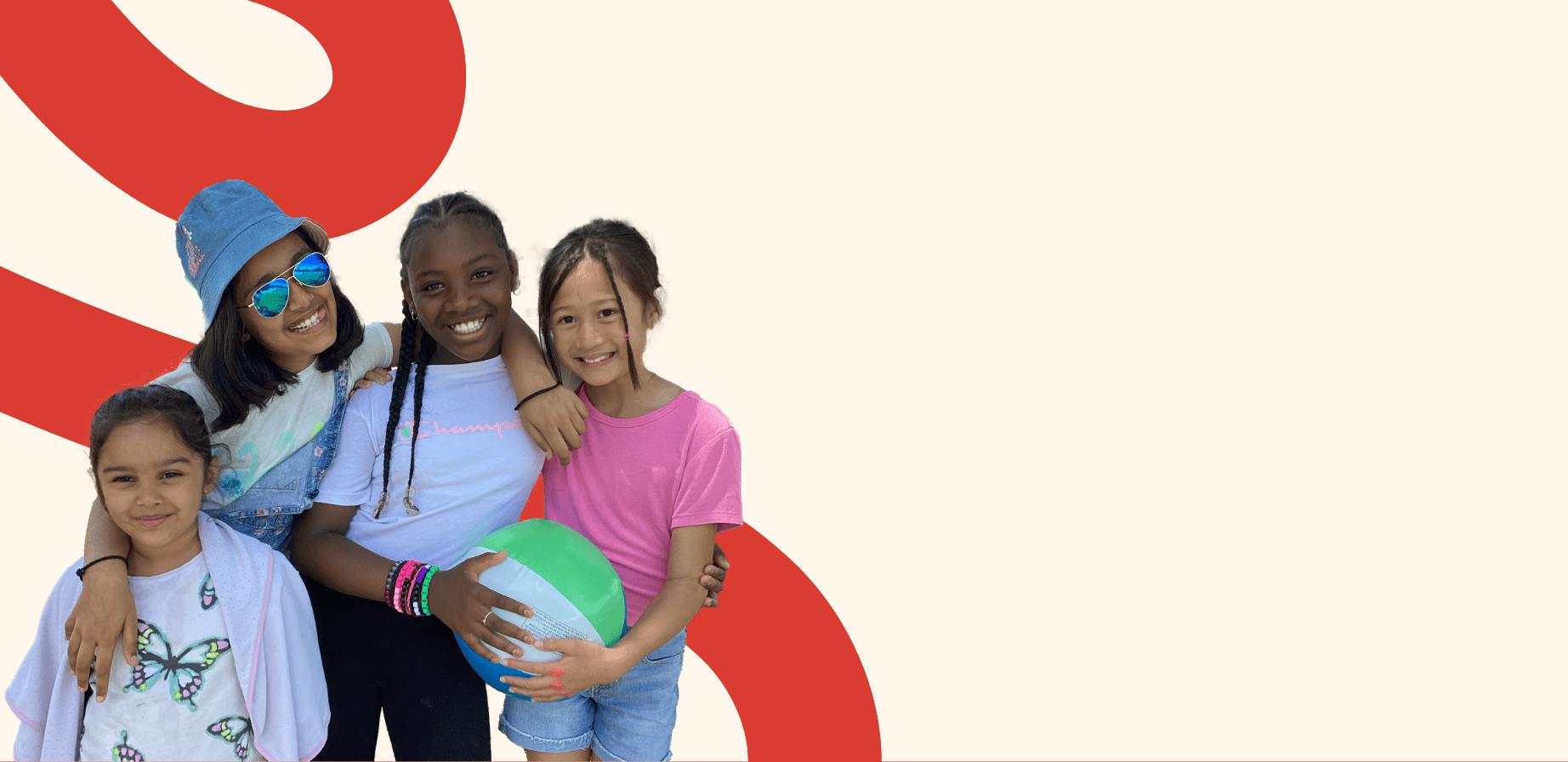 Photo of four LiftED program participants smiling at the camera, with two of the participants holding a beachball together